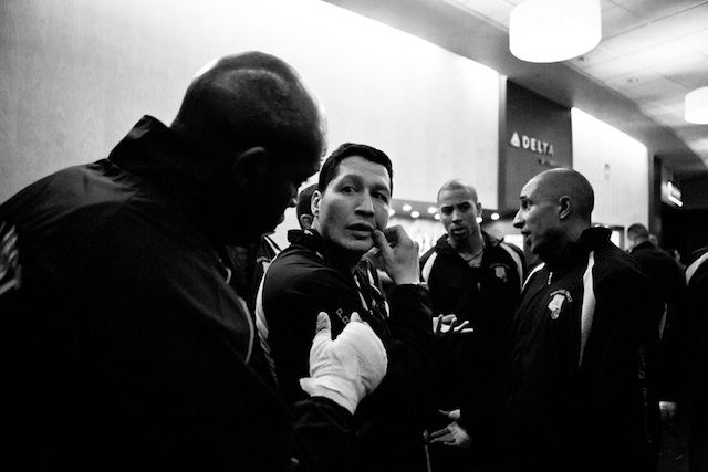 NYPD Boxing President and Lieutenant Dave Siev (center) speaks to a fighter before the match